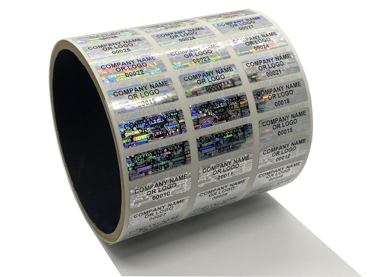 2,000 Silver Tamper Evident Security Holographic Label Seal Sticker, Rectangle 1" x 0.5" (25mm x 13mm). CustomPrinted. >Click on item details to Customize.